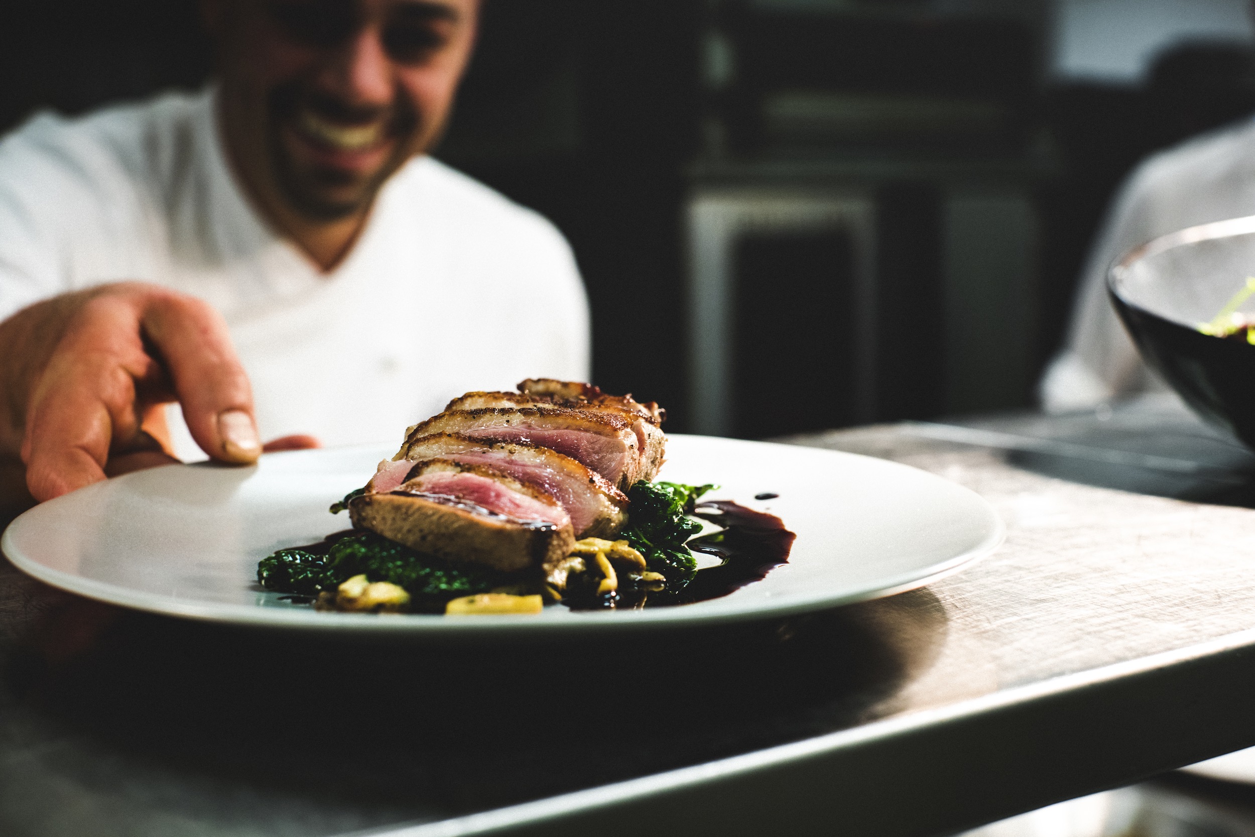 chef serving dinner plate