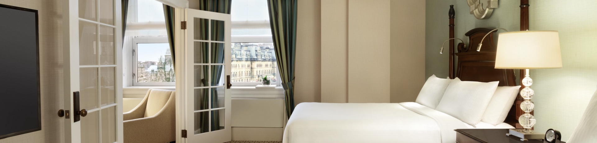 Two beds with french doors leading to sitting area