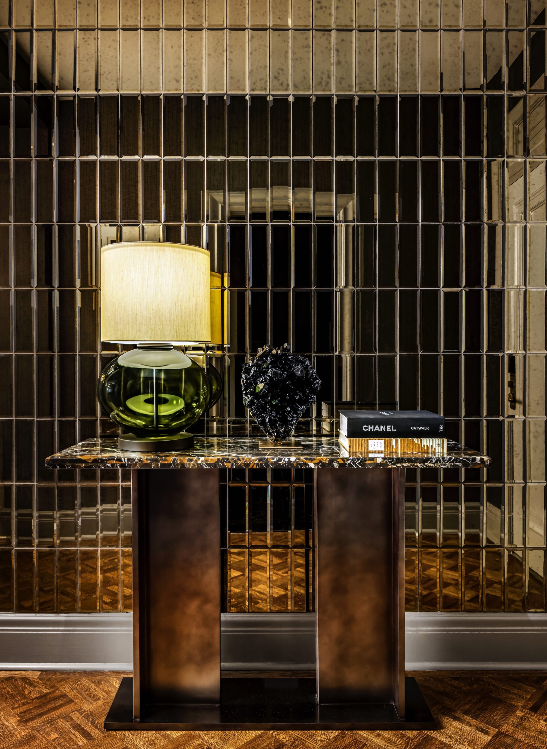 Marble table with a lamp in front of a tile wall