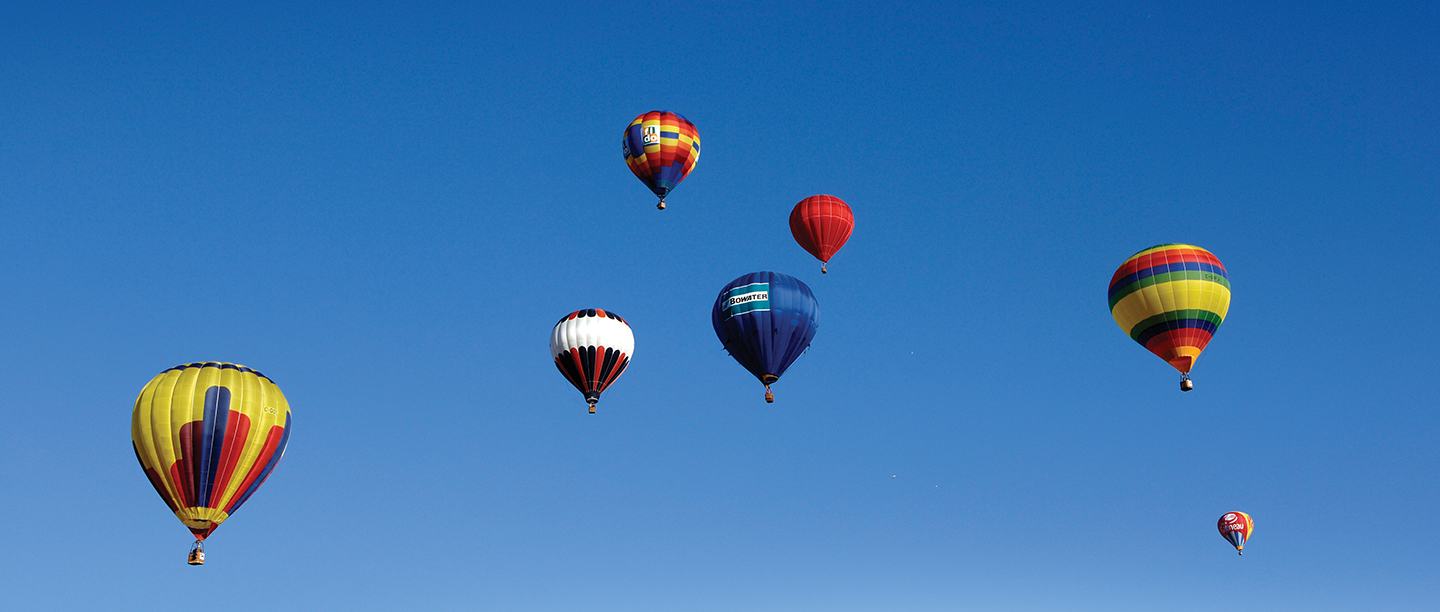 seven hot air balloons in the sky