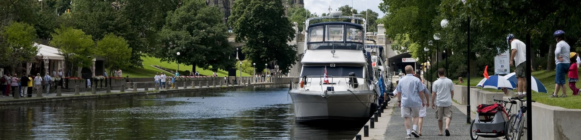 people walking on pathway next to rideau canal
