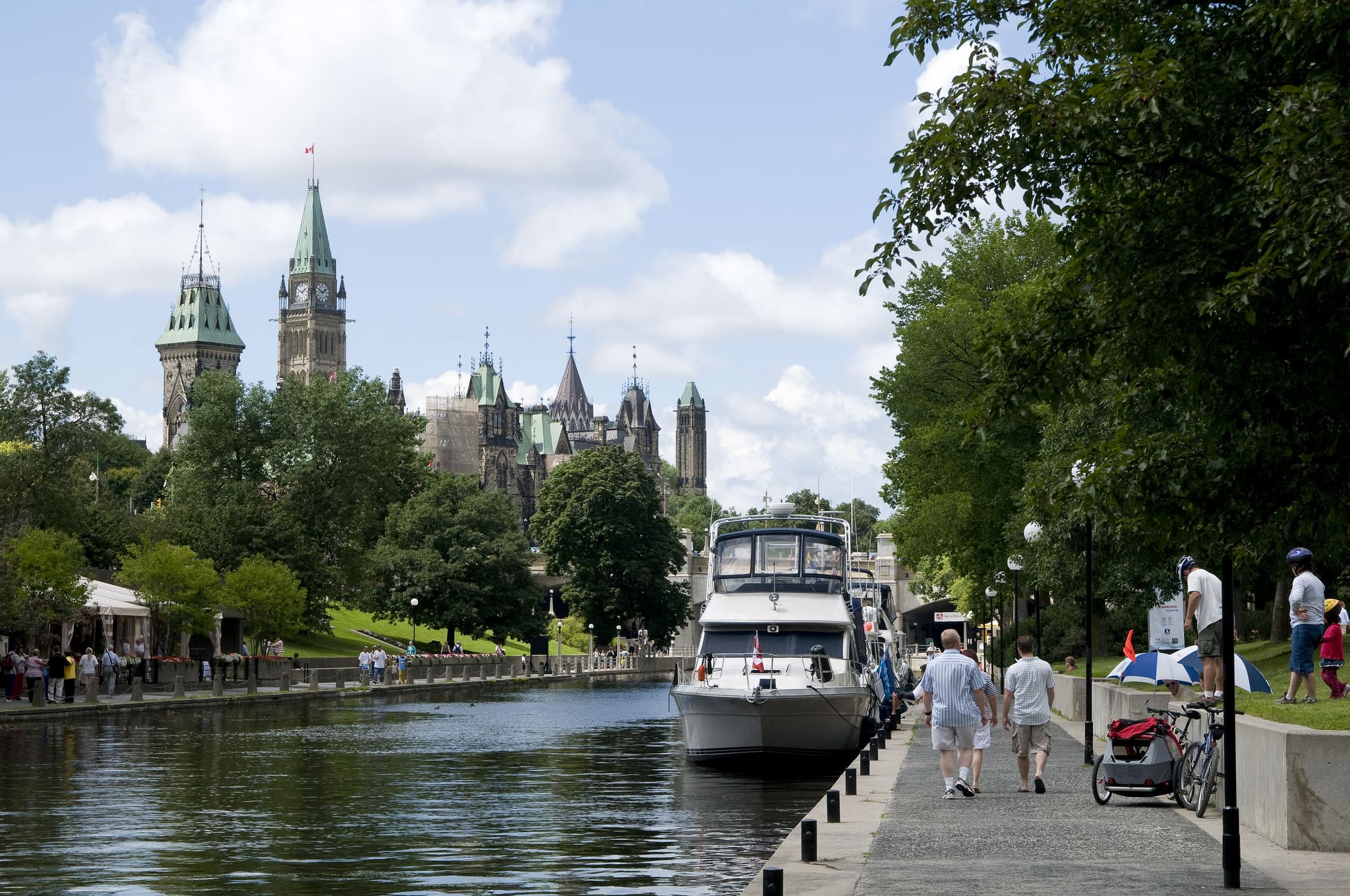 people walking on pathway next to rideau canal
