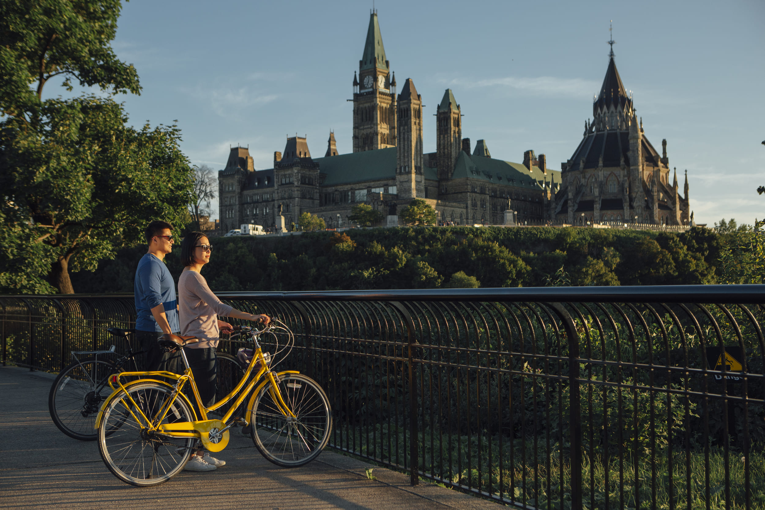 A couple Cycling in the Capital Parliament at morning