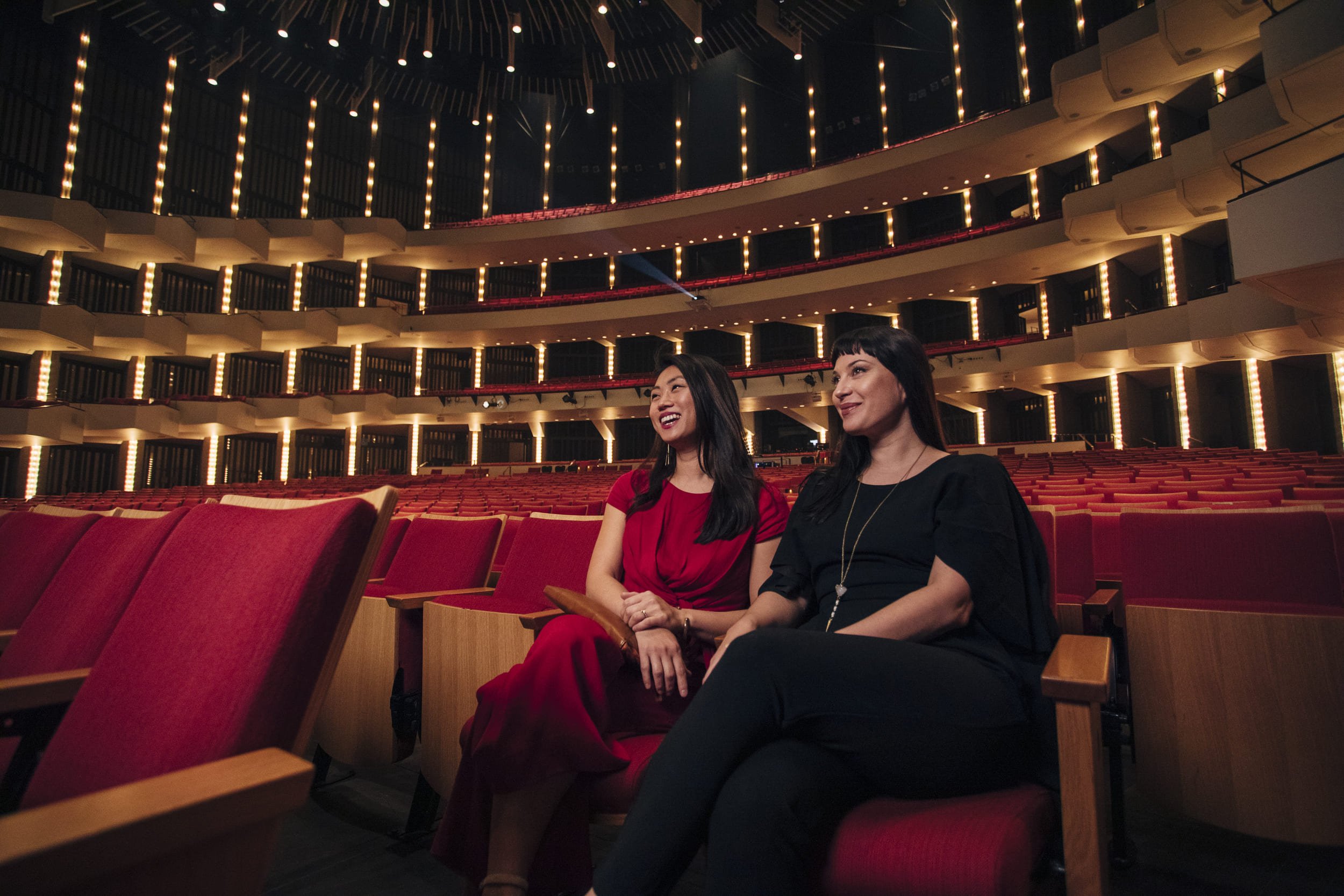 two women sitting in a theatre