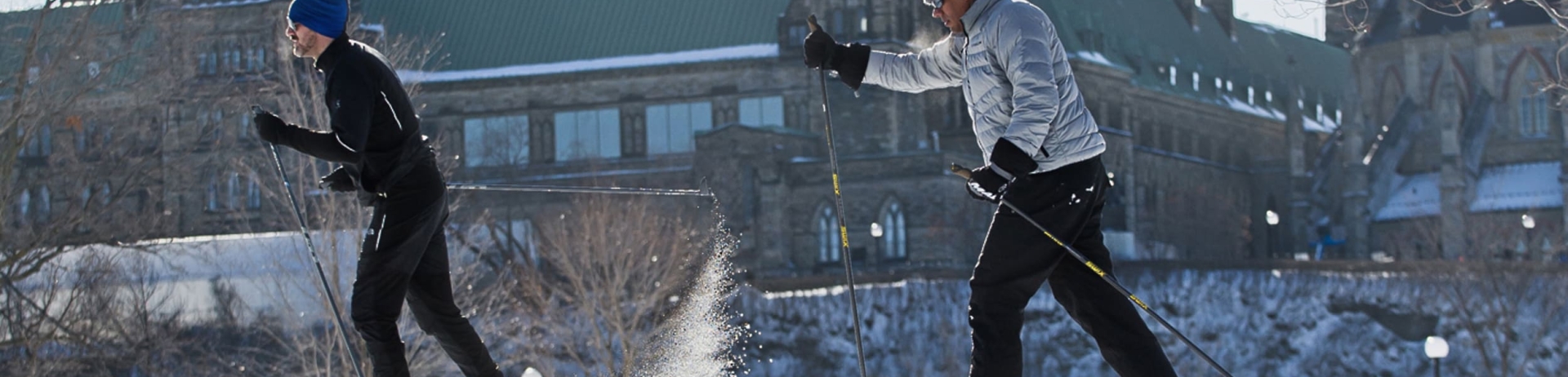 people cross-country skiing near the parliament building